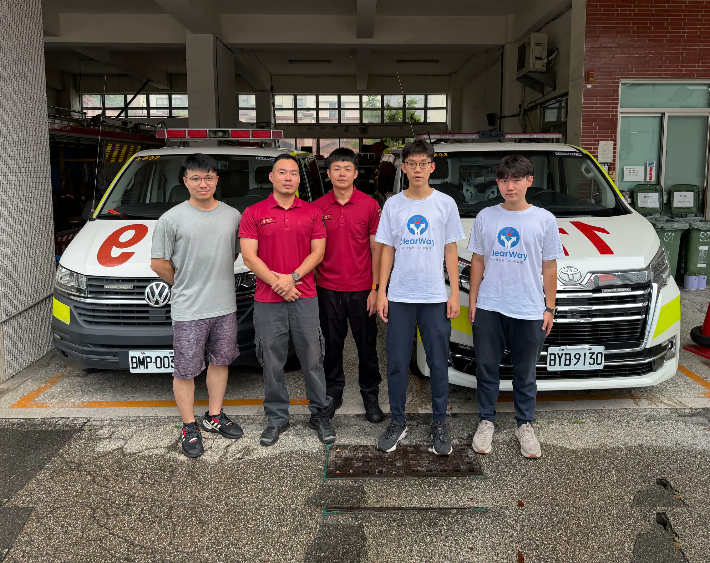 ClearWay team and firefighters standing between two ambulances
