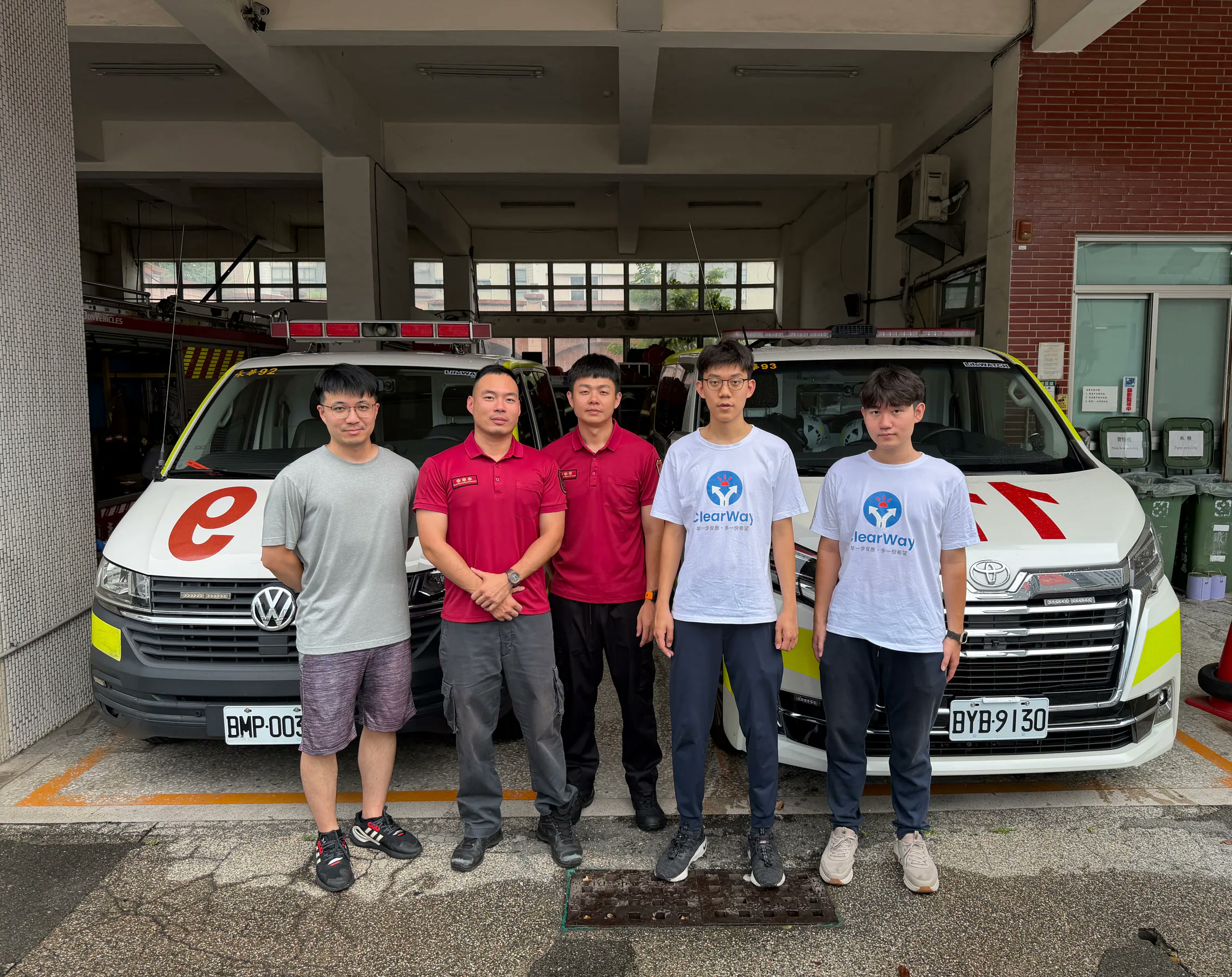 ClearWay team with firefighters in front of two ambulances